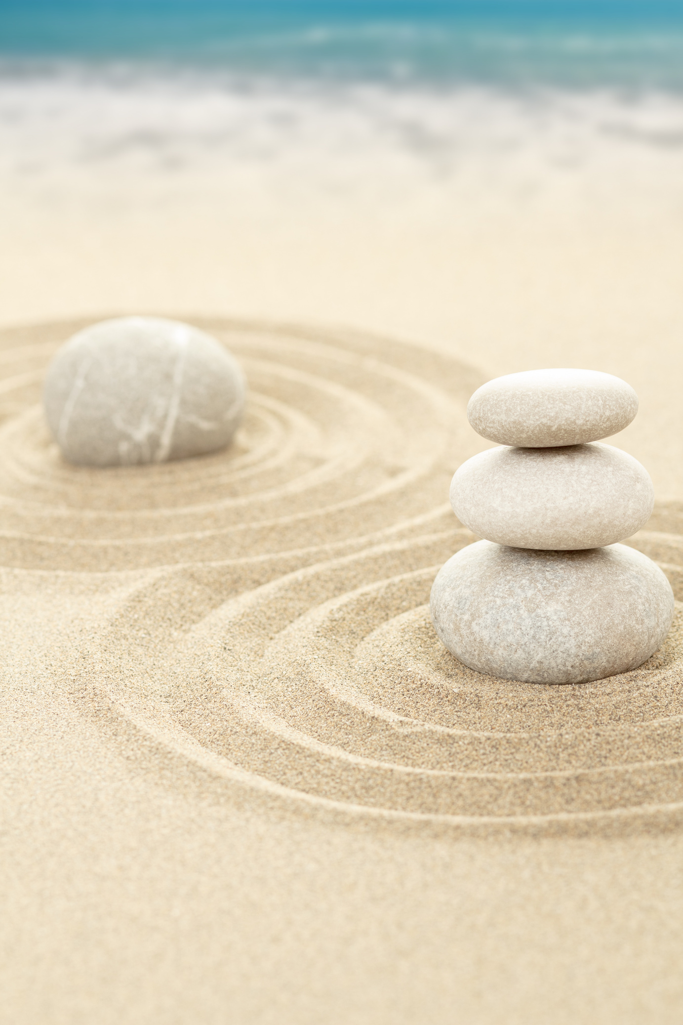 Balance Zen Stones in Sand with Sea in Background